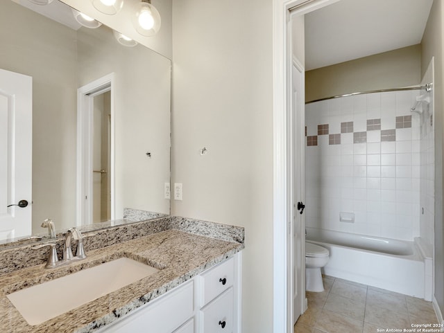 full bathroom with toilet, tile patterned floors, vanity, and tiled shower / bath combo