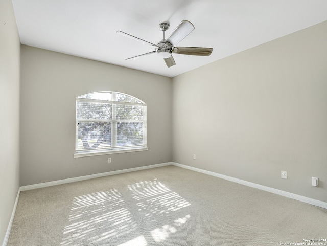 carpeted empty room with ceiling fan