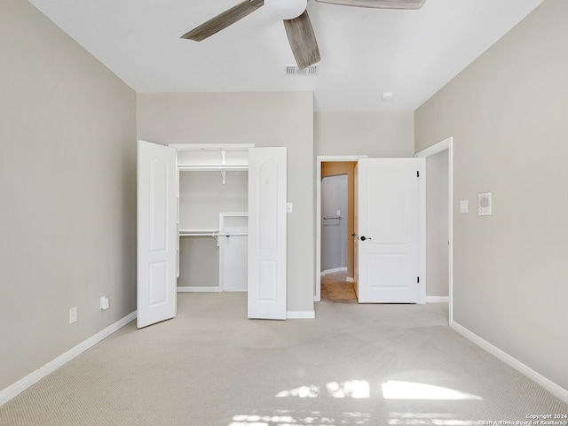 unfurnished bedroom featuring ceiling fan, light colored carpet, and a closet