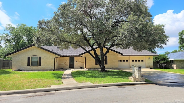 ranch-style home featuring a garage and a front yard