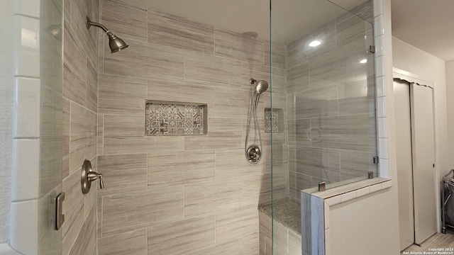 bathroom with a shower with door