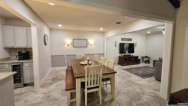 dining space with beverage cooler and ceiling fan