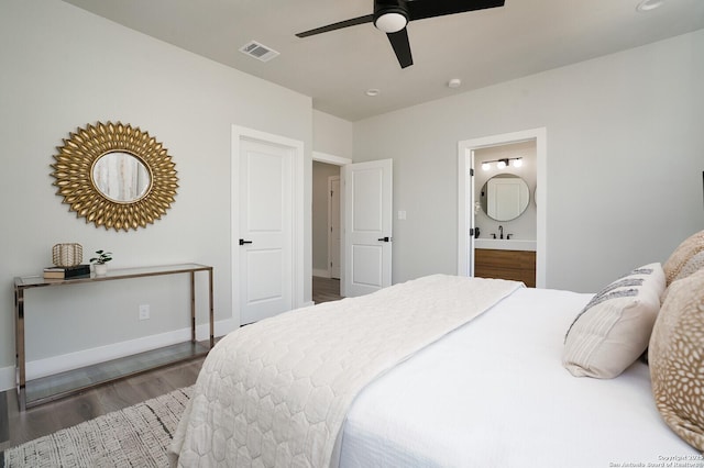 bedroom with dark hardwood / wood-style floors, ceiling fan, and ensuite bathroom