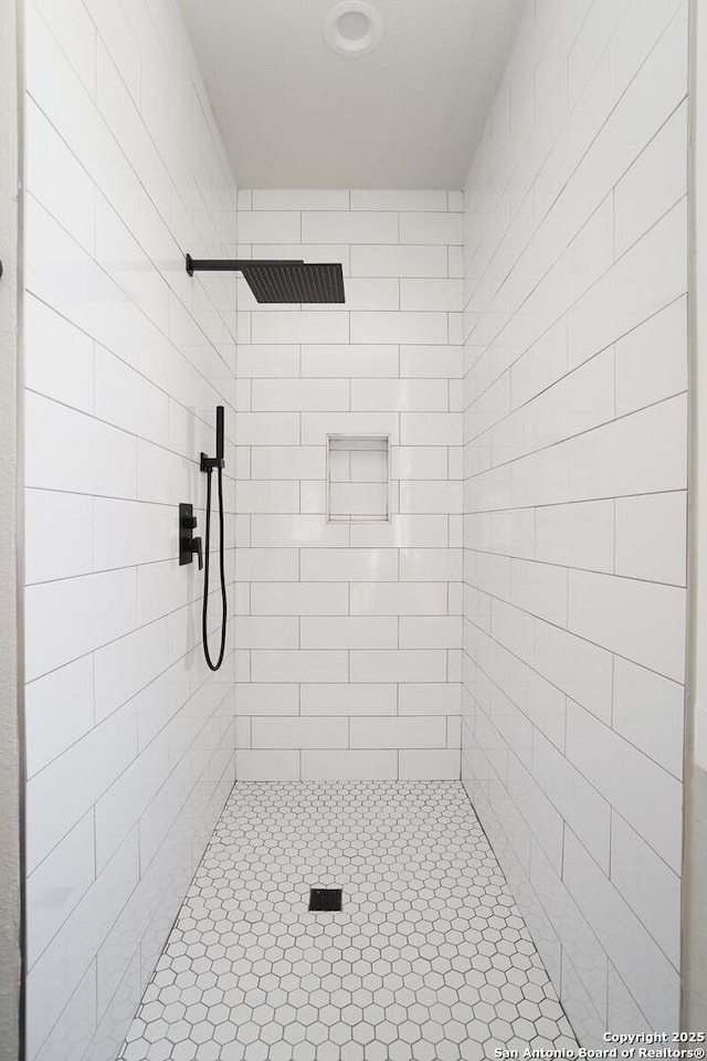 bathroom with a tile shower