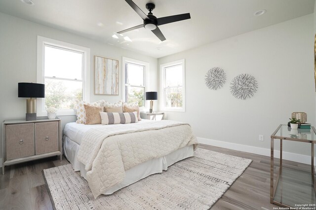 bedroom with ceiling fan and wood-type flooring