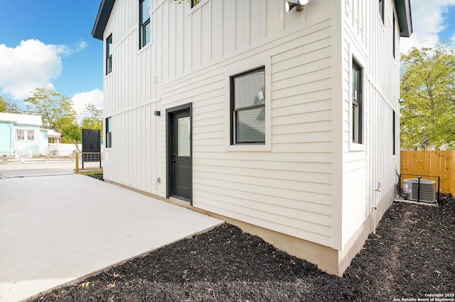 exterior space with central air condition unit and a patio