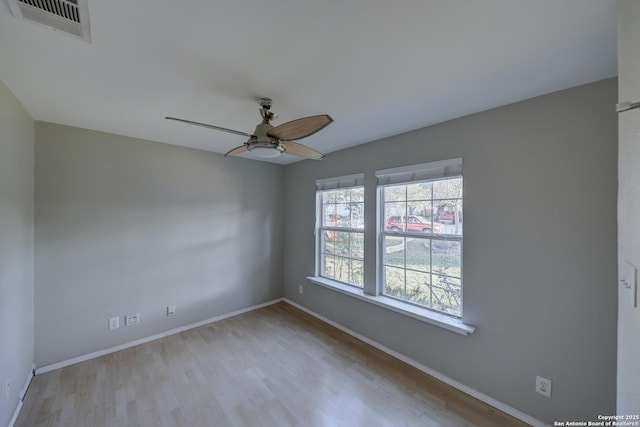 spare room featuring ceiling fan and light hardwood / wood-style flooring