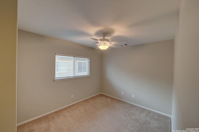 carpeted spare room with ceiling fan