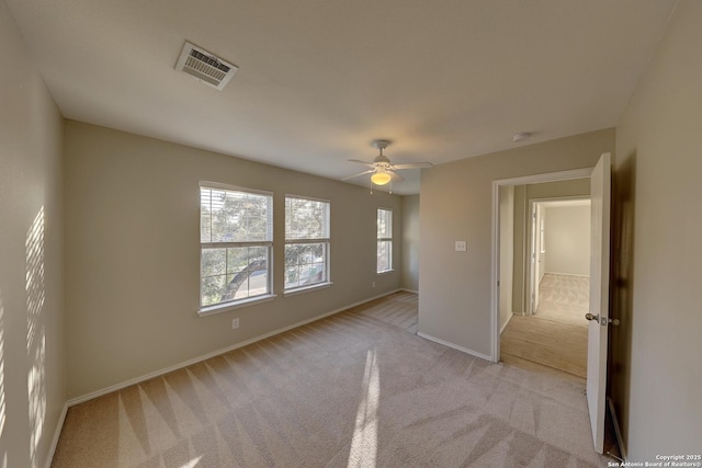 unfurnished bedroom with light colored carpet and ceiling fan