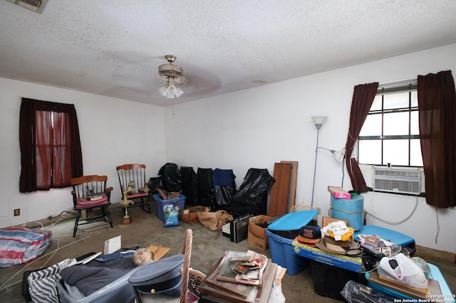 carpeted living room with ceiling fan, cooling unit, and a textured ceiling