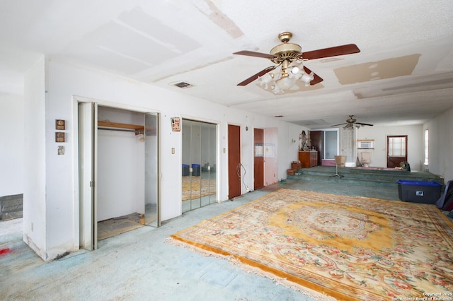 interior space with ceiling fan and multiple closets