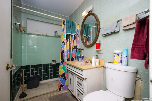 bathroom featuring toilet, vanity, tile walls, and walk in shower