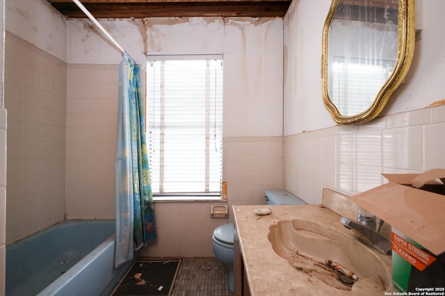 full bathroom with vanity, toilet, tile walls, and shower / bath combo with shower curtain