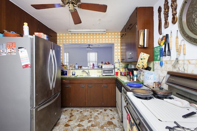 kitchen with sink, ceiling fan, dark brown cabinets, kitchen peninsula, and stainless steel appliances