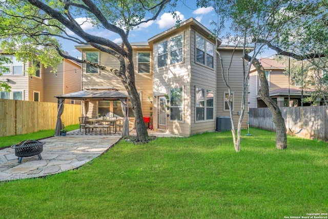 rear view of house featuring a yard, central AC, an outdoor fire pit, and a patio area