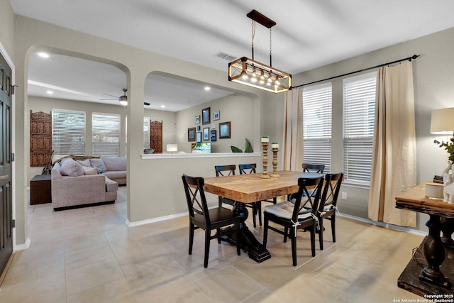 dining space with ceiling fan and light tile patterned flooring