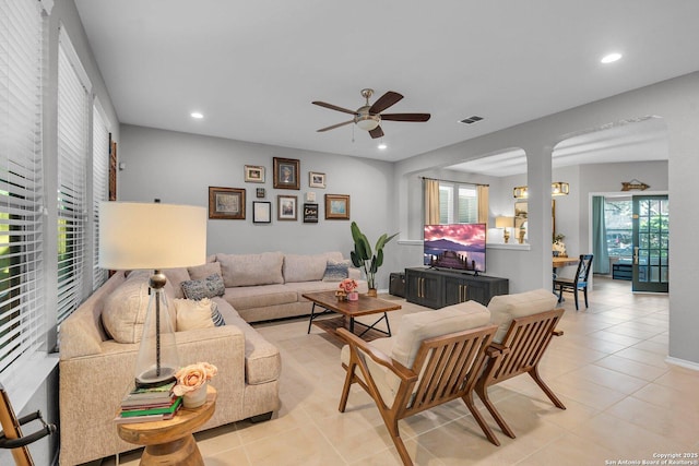 tiled living room featuring ceiling fan