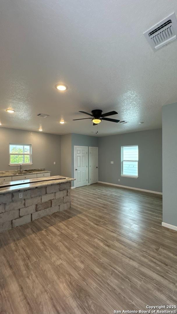 interior space featuring hardwood / wood-style floors, a healthy amount of sunlight, and a textured ceiling