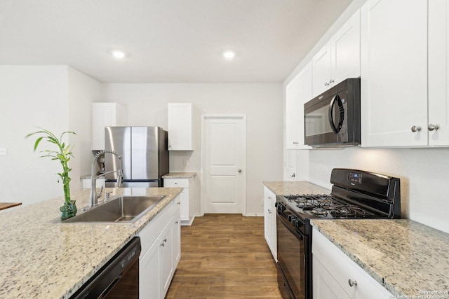 kitchen featuring light stone counters, dark wood-type flooring, sink, black appliances, and white cabinetry