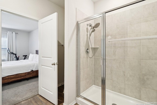 bathroom featuring hardwood / wood-style flooring and walk in shower