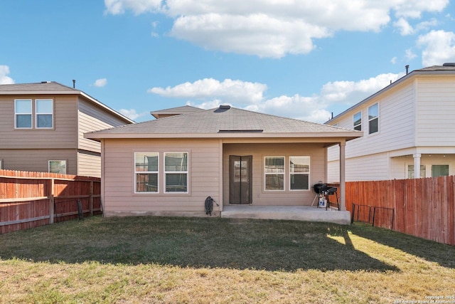 back of property featuring a lawn and a patio