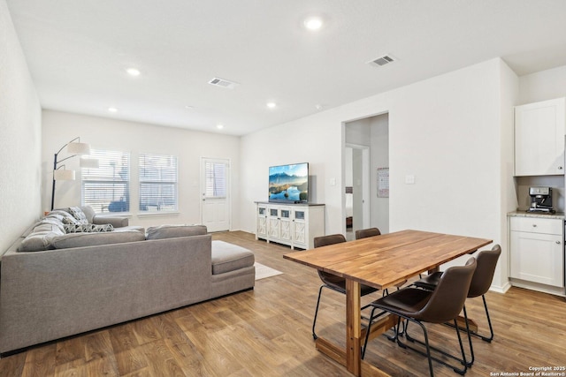 dining space with light wood-type flooring