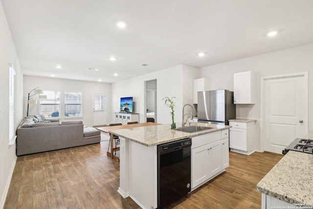 kitchen with dishwasher, white cabinetry, a kitchen island with sink, and sink