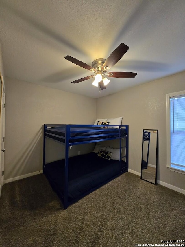 bedroom featuring dark carpet and ceiling fan