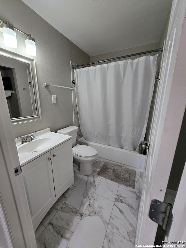 full bathroom featuring shower / tub combo, vanity, a textured ceiling, and toilet