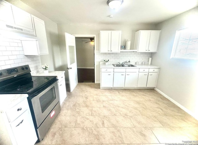 kitchen with stainless steel range with electric cooktop, sink, decorative backsplash, ceiling fan, and white cabinetry