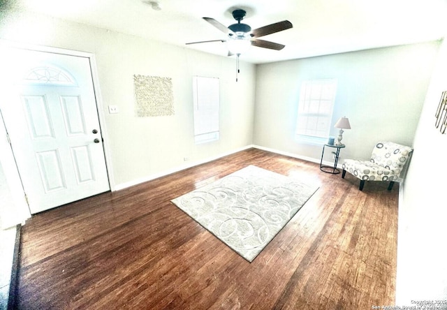 sitting room with wood-type flooring and ceiling fan