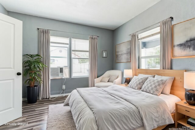 bedroom featuring cooling unit and wood-type flooring