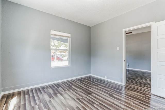 empty room with hardwood / wood-style floors