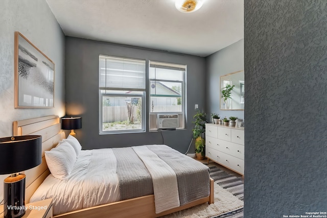 bedroom featuring cooling unit and wood-type flooring