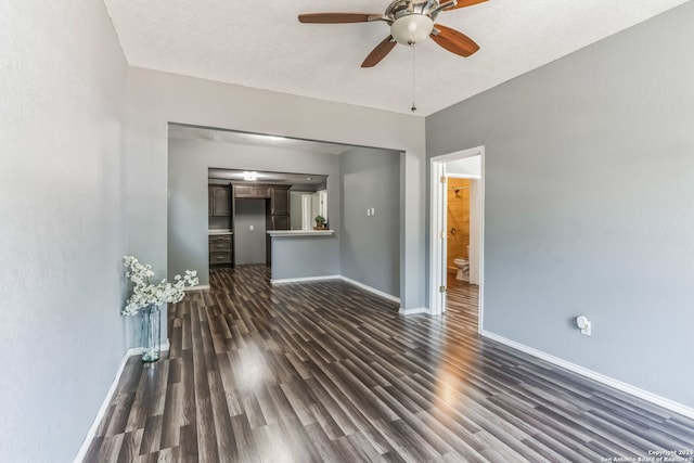 interior space featuring ceiling fan, dark hardwood / wood-style flooring, and a textured ceiling