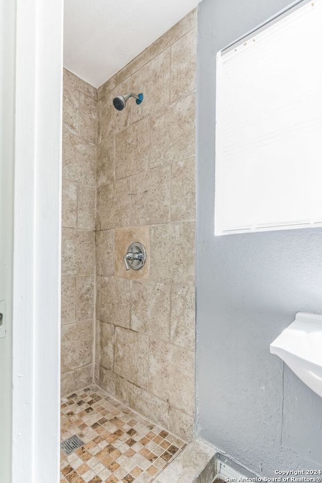 bathroom with a tile shower