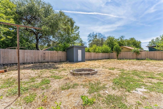 view of yard with a fire pit and a storage unit