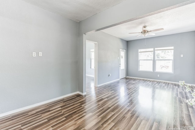 spare room with ceiling fan, wood-type flooring, and a textured ceiling