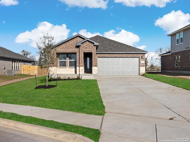 view of front of house featuring central air condition unit, a front lawn, and a garage