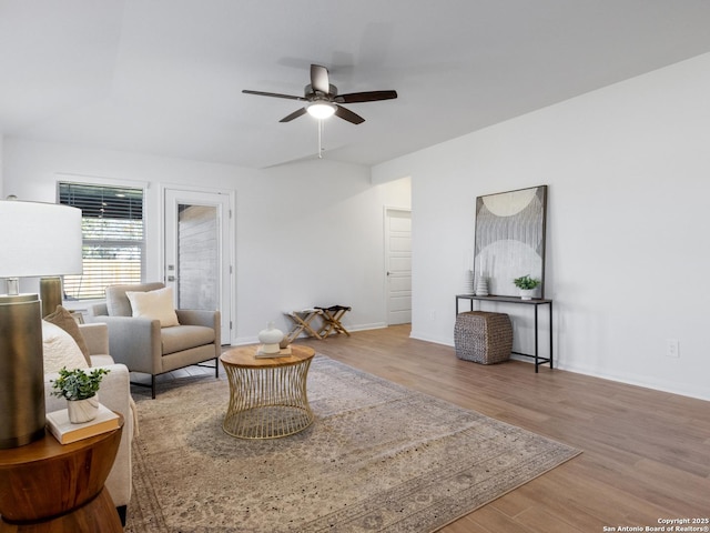 living room featuring ceiling fan and hardwood / wood-style floors