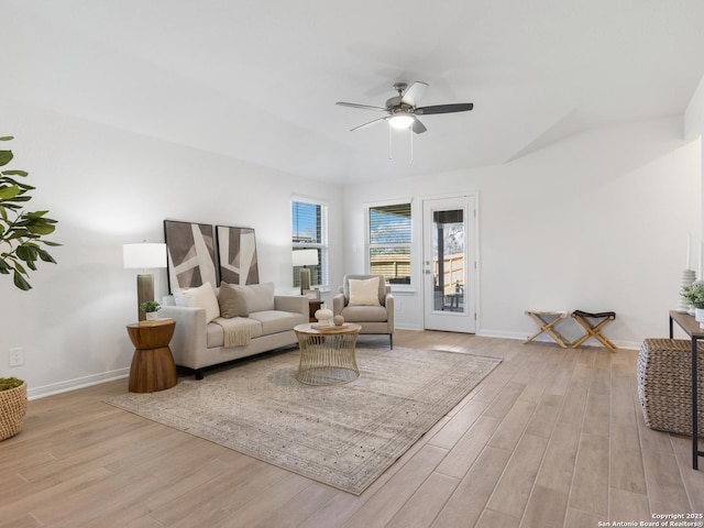 living room featuring ceiling fan and light hardwood / wood-style floors