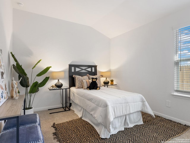 bedroom with carpet flooring and lofted ceiling