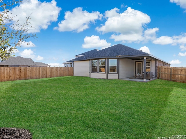 back of property featuring a yard and a patio