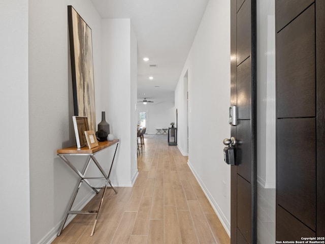 corridor with light wood-type flooring