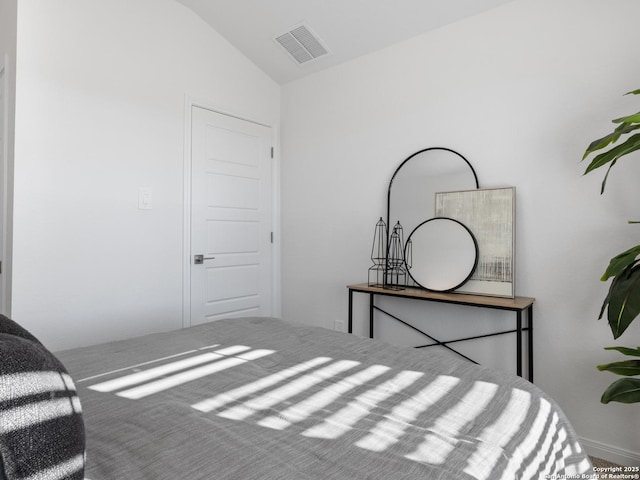 bedroom featuring carpet and vaulted ceiling