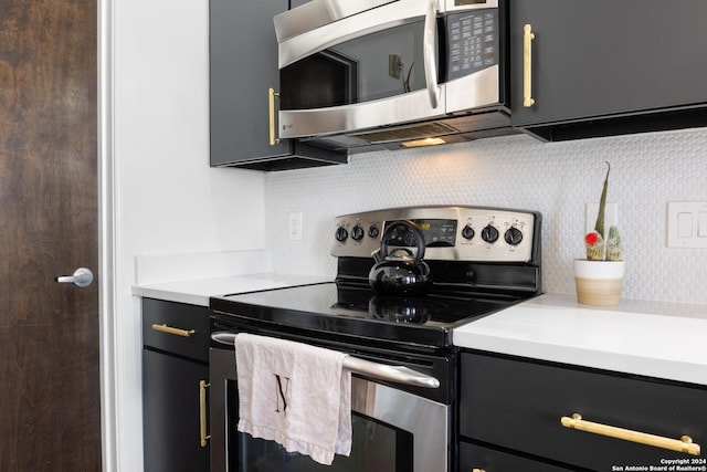 kitchen with appliances with stainless steel finishes and tasteful backsplash