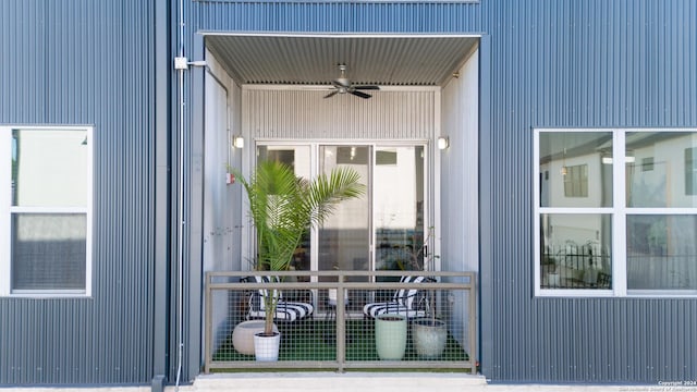 view of exterior entry featuring ceiling fan