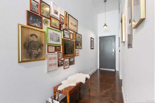 hallway featuring a towering ceiling