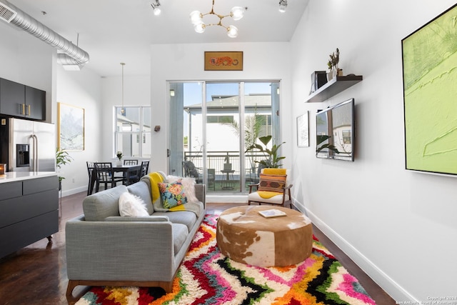 living room with a high ceiling and an inviting chandelier