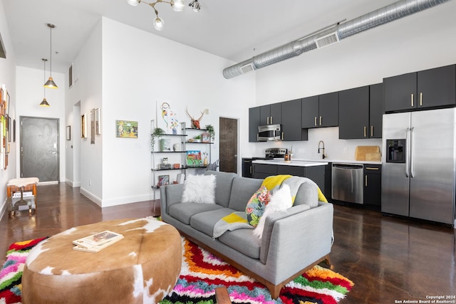 living room with sink and a high ceiling